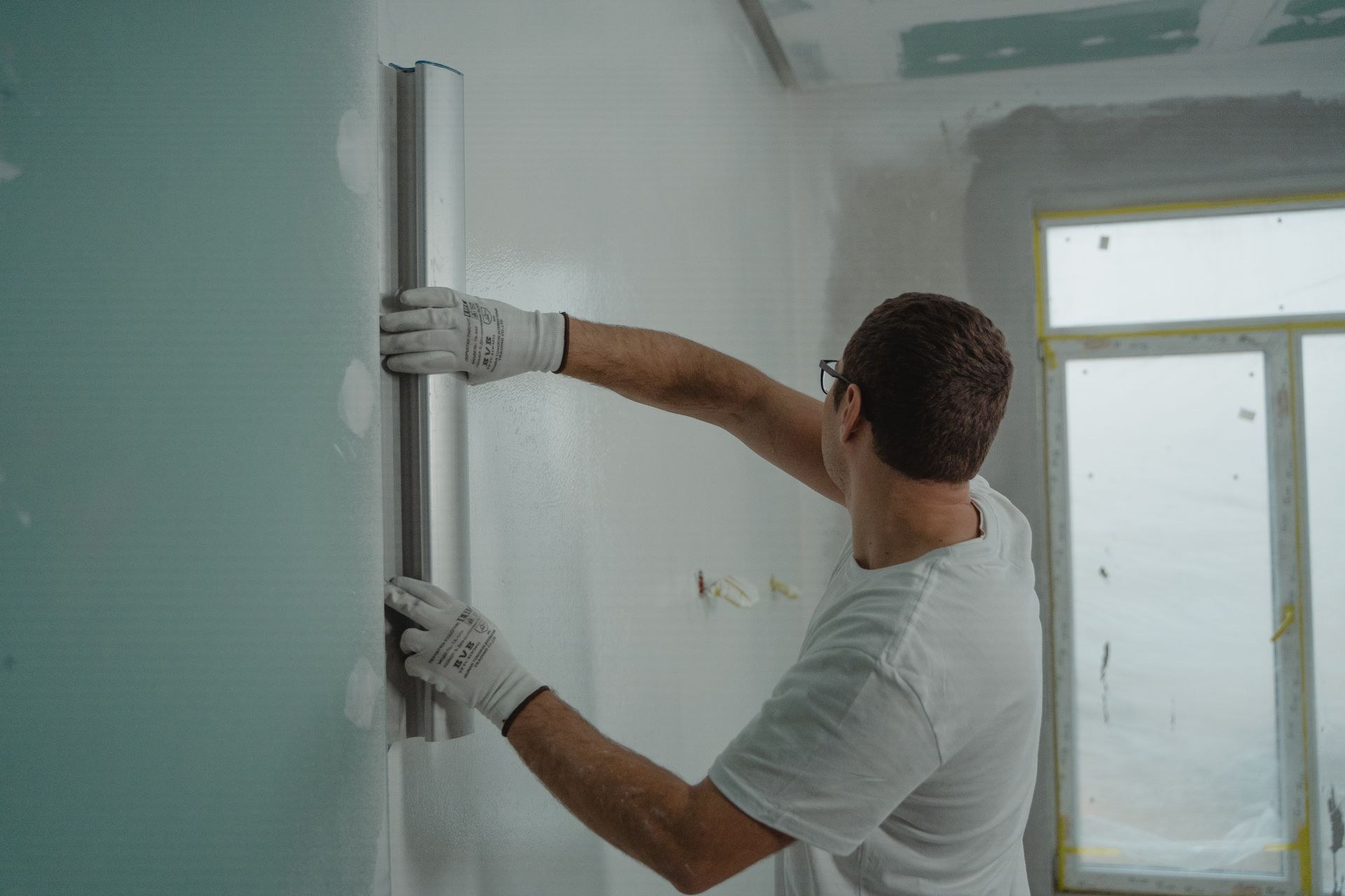 Measuring and marking a wall during renovation maintenance
